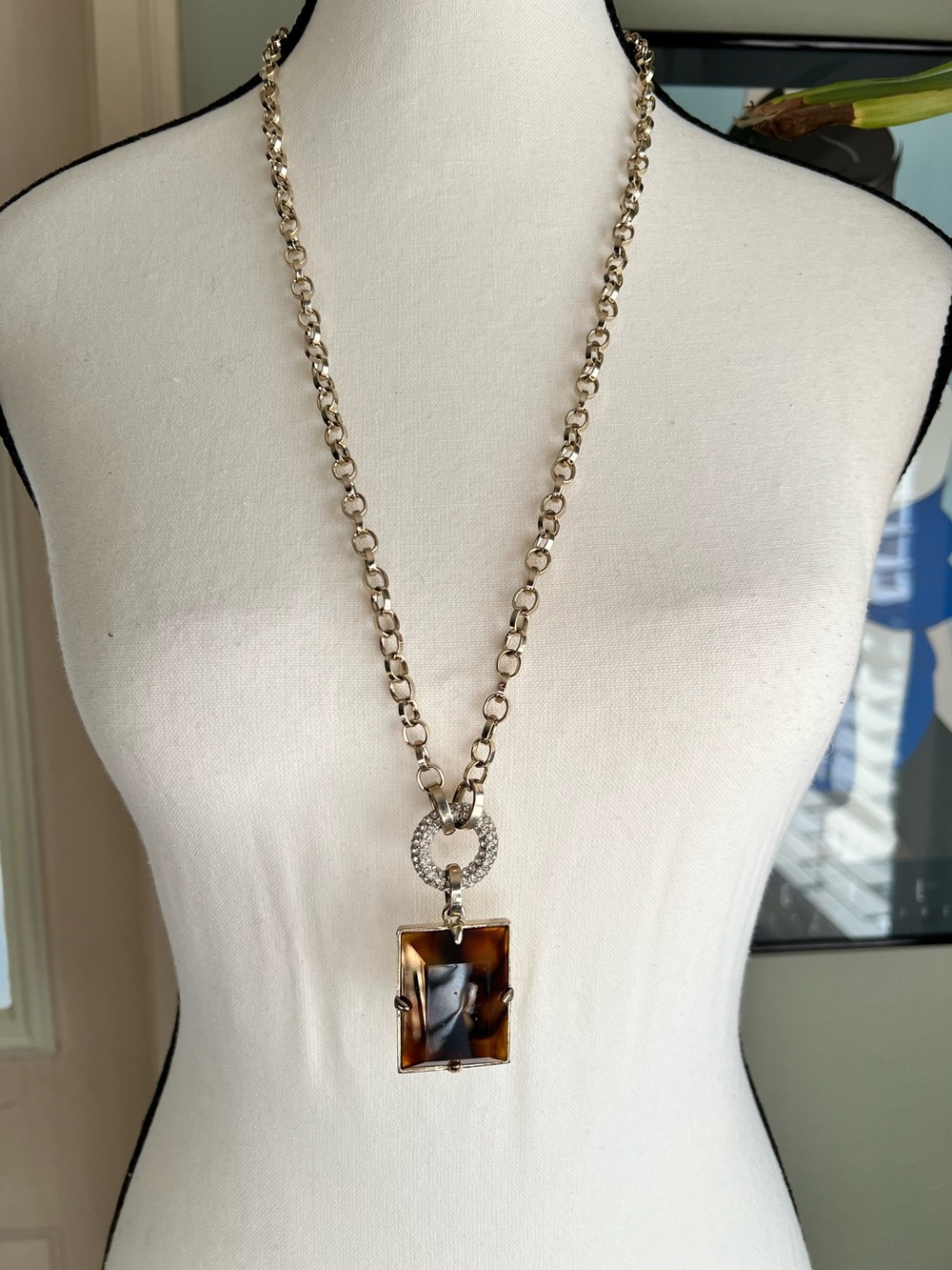 Ann Taylor opera length gold tone necklace with faux tortoise shell toggle close